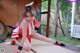 A woman in a red and white outfit is posing for a picture.