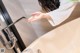 A woman is washing her hands in a bathtub.